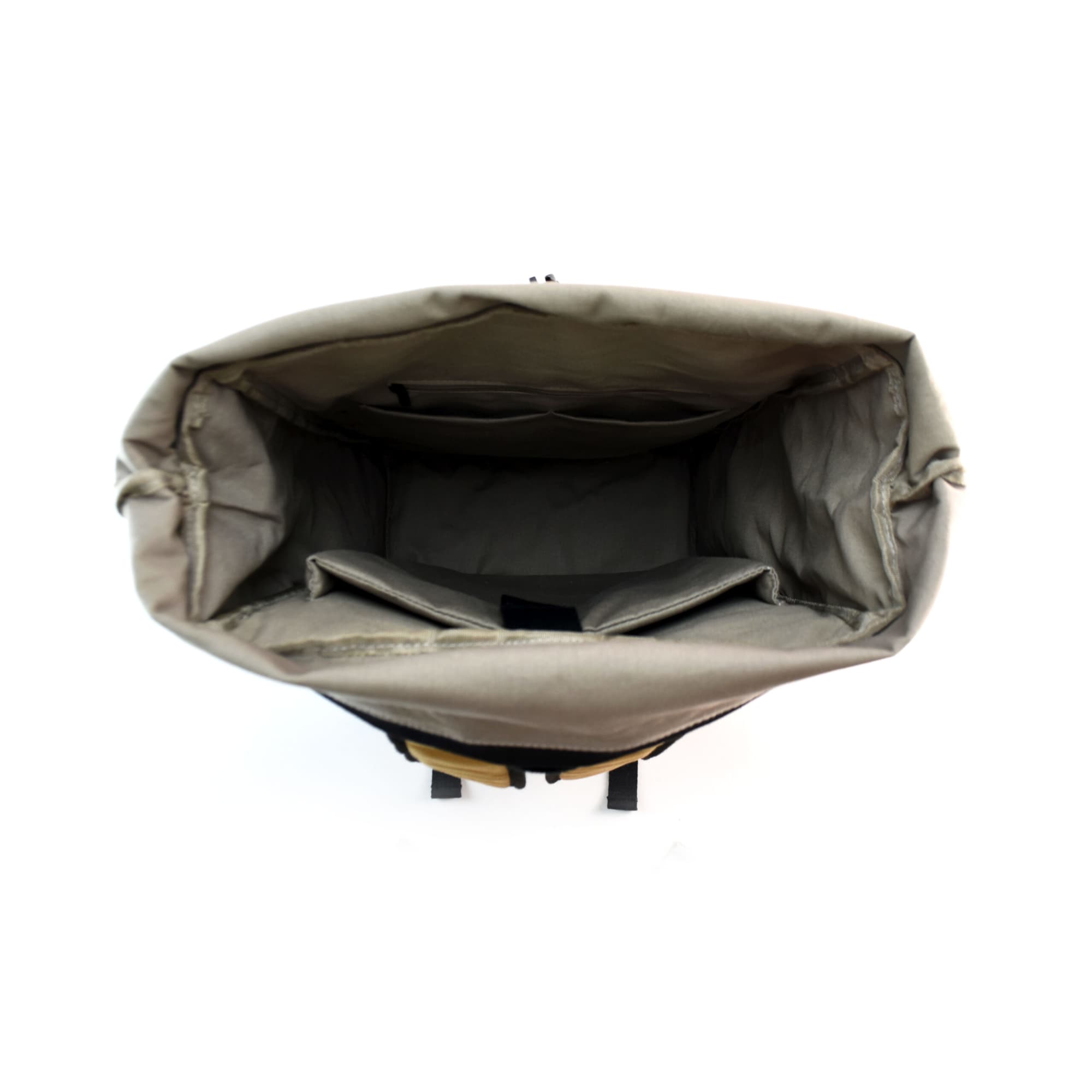 An open backpack in grey with multiple compartments and a top flap, featuring a logo on the exterior.