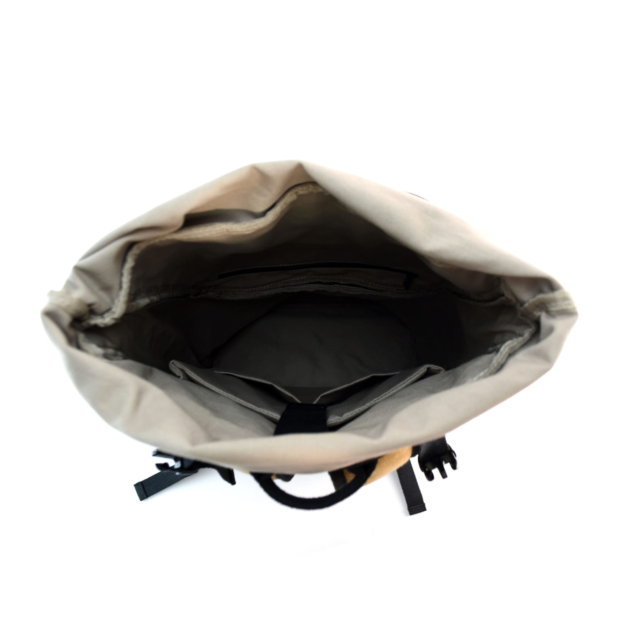 A tan laptop backpack with a spacious, open interior and adjustable straps. Features a logo on the exterior.
