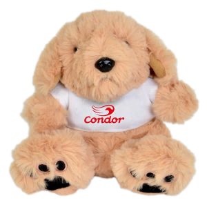 A soft, beige plush puppy sitting upright, featuring a white shirt with a logo. Its paws and ears are dark brown.