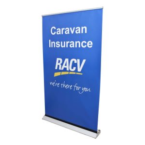 A blue roll-up banner featuring the RACV logo and text about caravan insurance, with an Australian Made emblem.