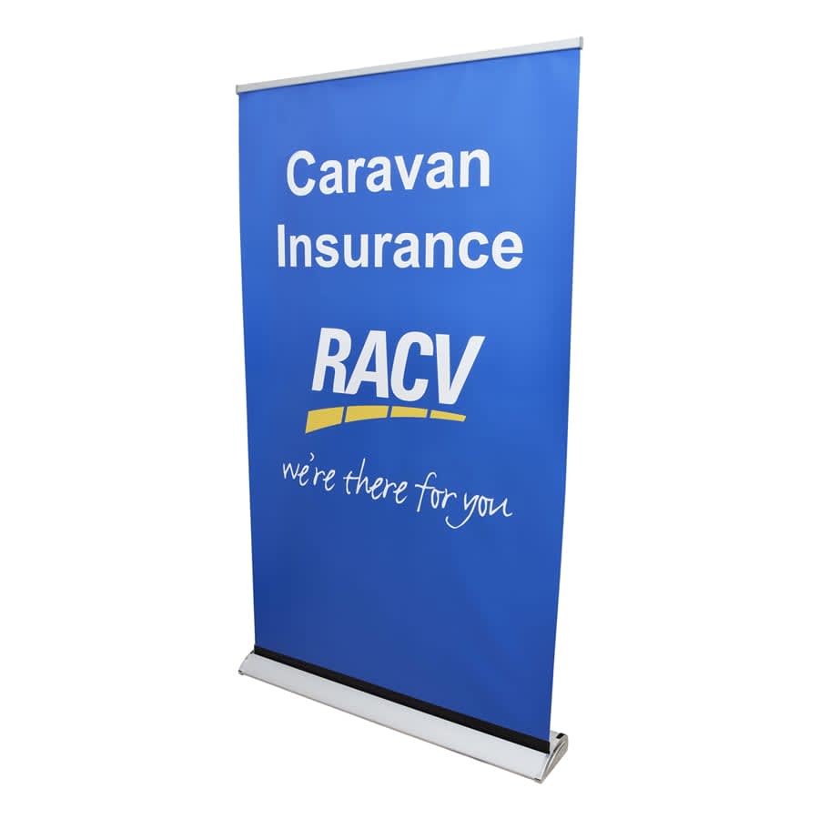 A blue roll-up banner featuring the RACV logo and text about caravan insurance, with an Australian Made emblem.