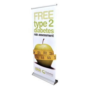 A deluxe 850mm roll-up banner featuring a green apple, a measuring tape, and a logo. Predominantly white and yellow.