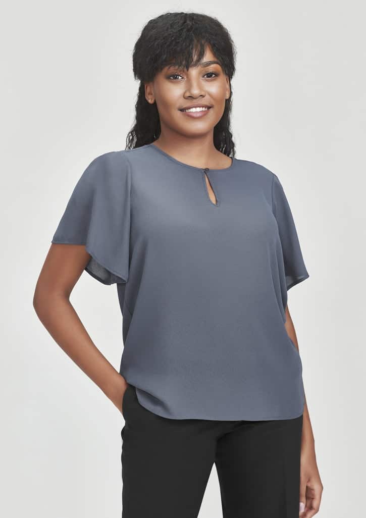 A grey short sleeve blouse with a round neck and keyhole detail, featuring a logo on the side.