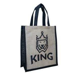 A jute tote bag in natural and navy blue featuring a lion logo and the word "KING."