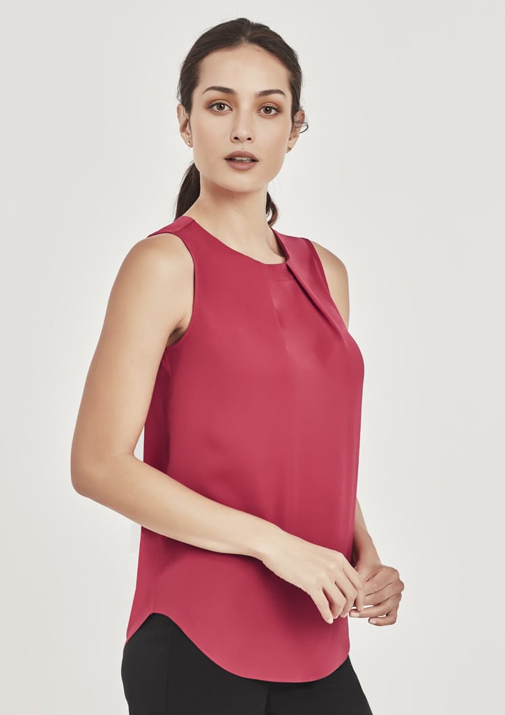 A sleeveless blouse in deep red with pleat detail, featuring a rounded hem and a subtle brand logo.