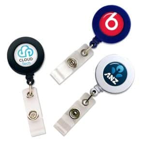 Three retractable ID card holders in black, blue, and silver, each featuring a different logo.
