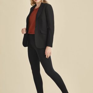 A model wearing black high-rise pull-on corporate leggings with a fitted blazer and a rust top, styled with loafers.