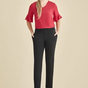Mid-rise pull-on pants in black, styled with a red top, featuring a sleek design and pockets.
