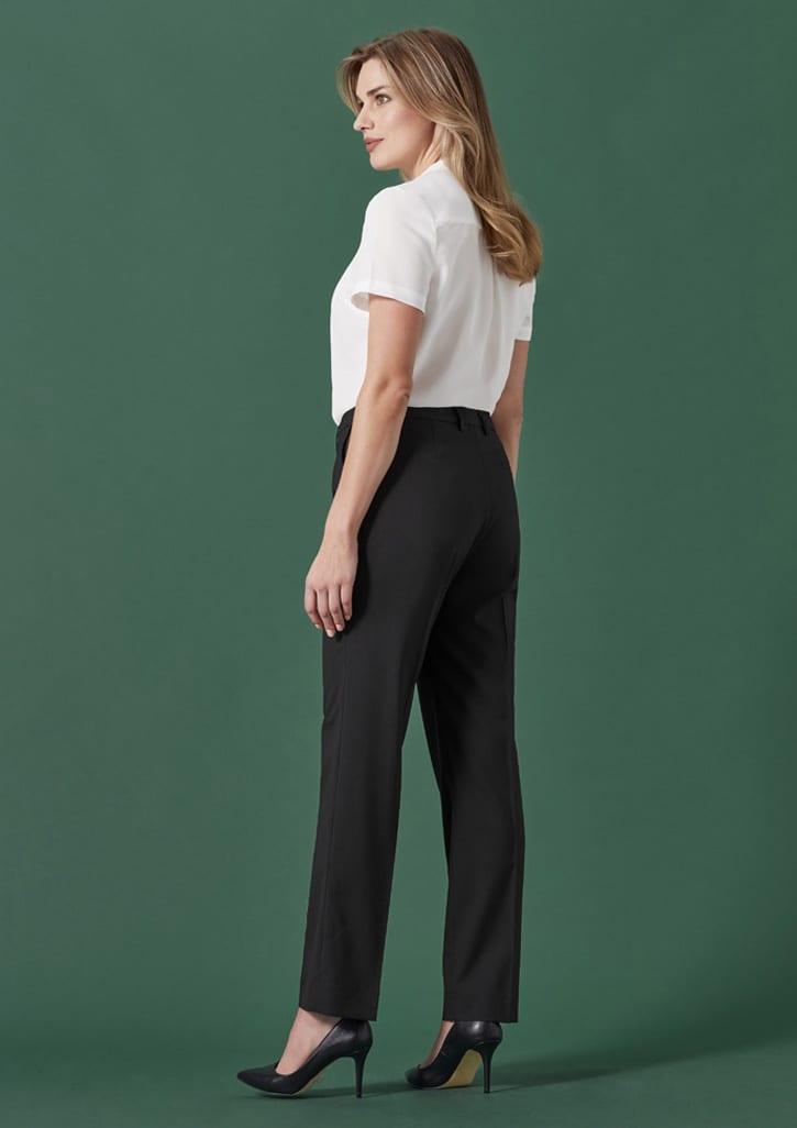 A pair of black tapered adjustable waist pants displayed on a model from a side view against a green background.