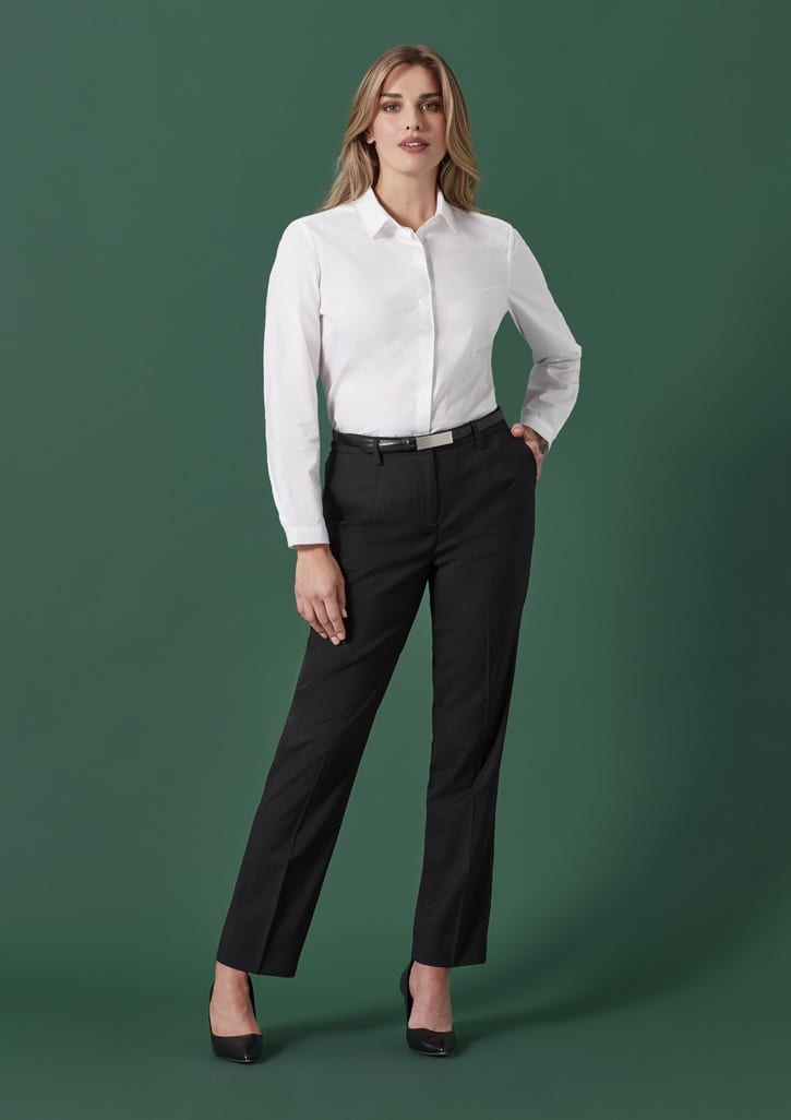 A model wearing black tapered adjustable waist pants and a white shirt, set against a green background.