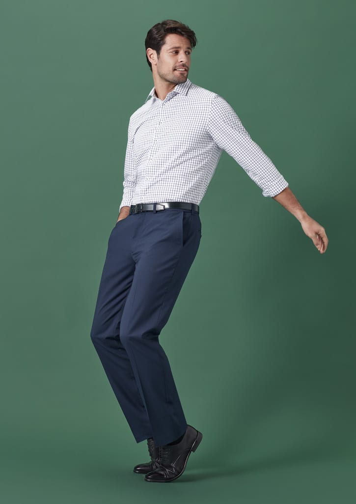 Men's straight leg slacks in navy blue, paired with a checked shirt, against a green background.