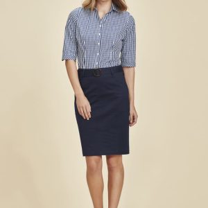 A woman wearing a navy mid waist stretch chino skirt paired with a striped shirt. The skirt features a belt and has a casual look.