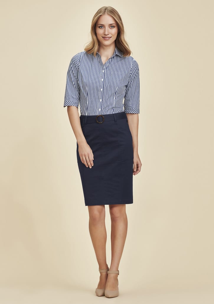 A woman wearing a navy mid waist stretch chino skirt paired with a striped shirt. The skirt features a belt and has a casual look.