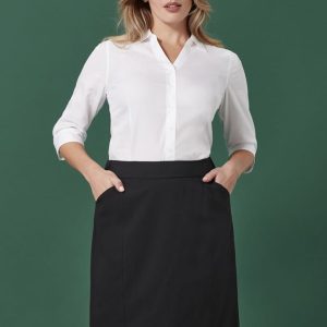 A pencil skirt in black, featuring a fitted design and pockets, paired with a white button-up shirt.