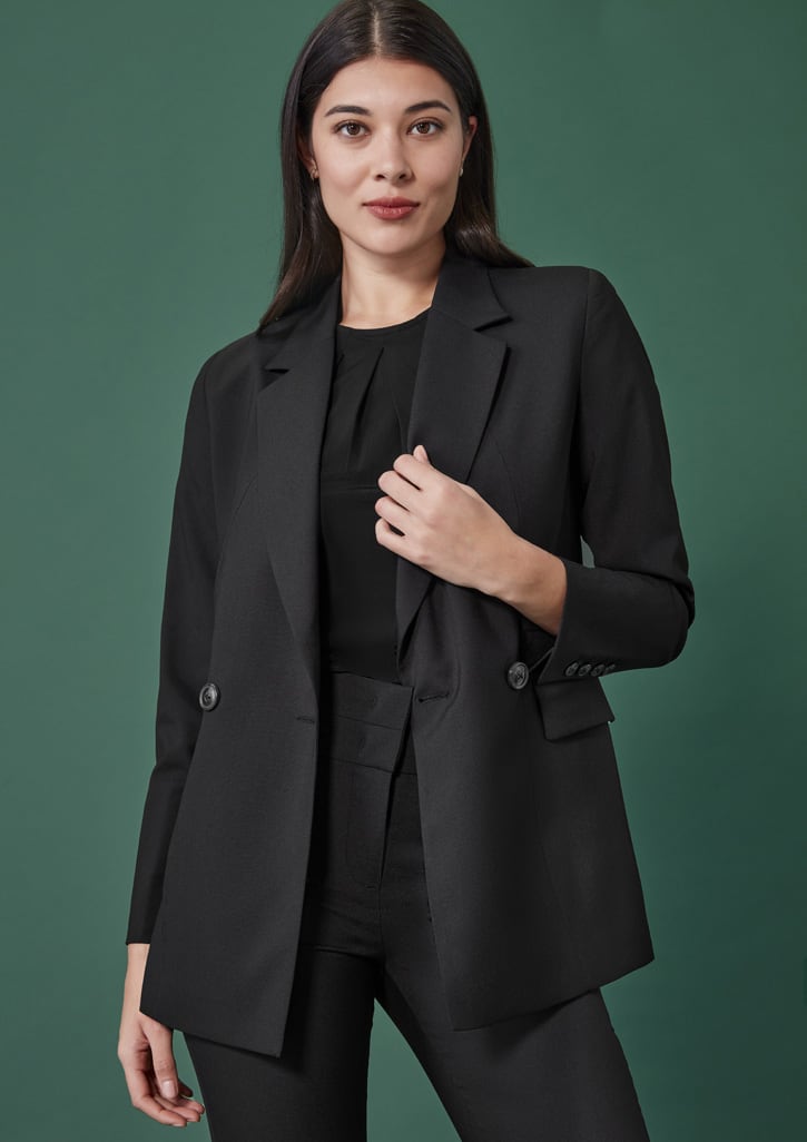 A black double-breasted longline jacket with a relaxed fit, featuring buttons and flap pockets, set against a green background.
