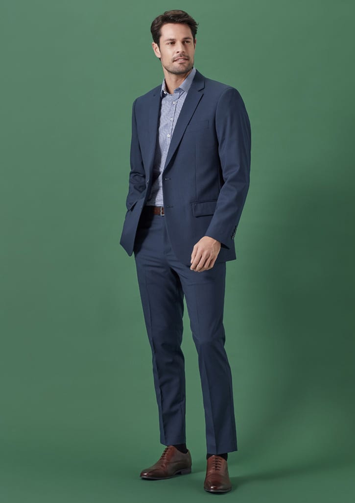A tailored men's jacket in dark blue, paired with a patterned shirt and smart trousers, featuring a subtle logo.