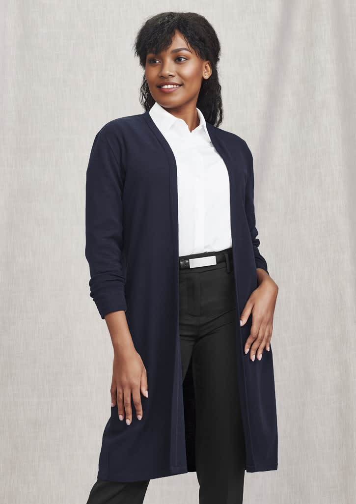 A navy longline cardigan with a clean, open front and long sleeves, paired with a white shirt and black pants.