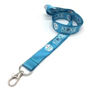 A blue lanyard with a silver clip, featuring printed logos and designs along its length.