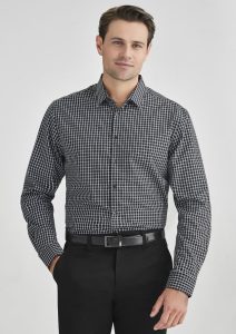 A black and white check pattern long sleeve button-up shirt worn by a man, paired with black trousers.