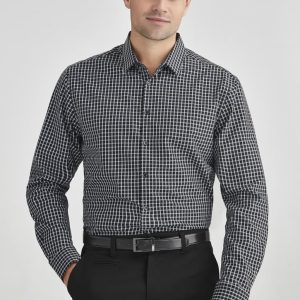 A black and white check pattern long sleeve button-up shirt worn by a man, paired with black trousers.