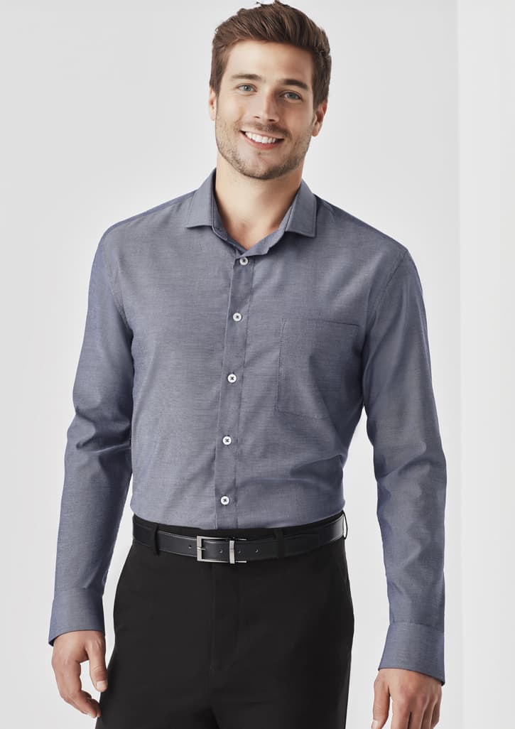 A long sleeve button-up shirt in a navy hue featuring a chest pocket and a brand logo.