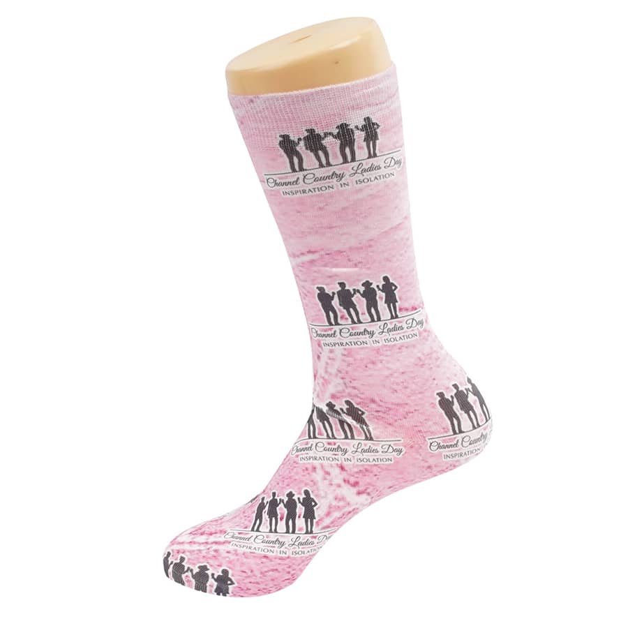 Pink dress sock featuring silhouetted figures and a logo, displayed on a sock mannequin.