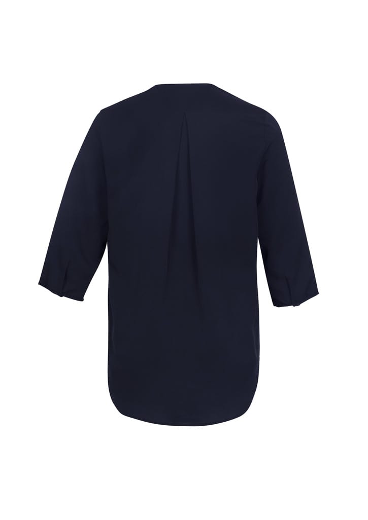 A women's longline blouse in navy blue with three-quarter sleeves and a back pleat, featuring a branded logo.