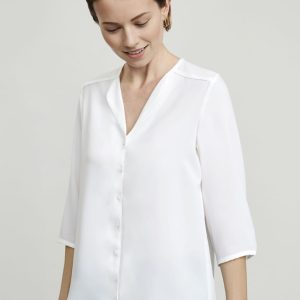 A button-up women's blouse in white with a v-neck and three-quarter sleeves, featuring a subtle sheen.