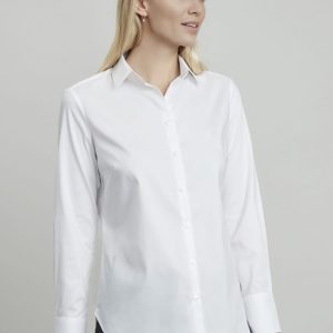 A white long sleeve button-up shirt on a model, featuring a classic collar and a curved hem.