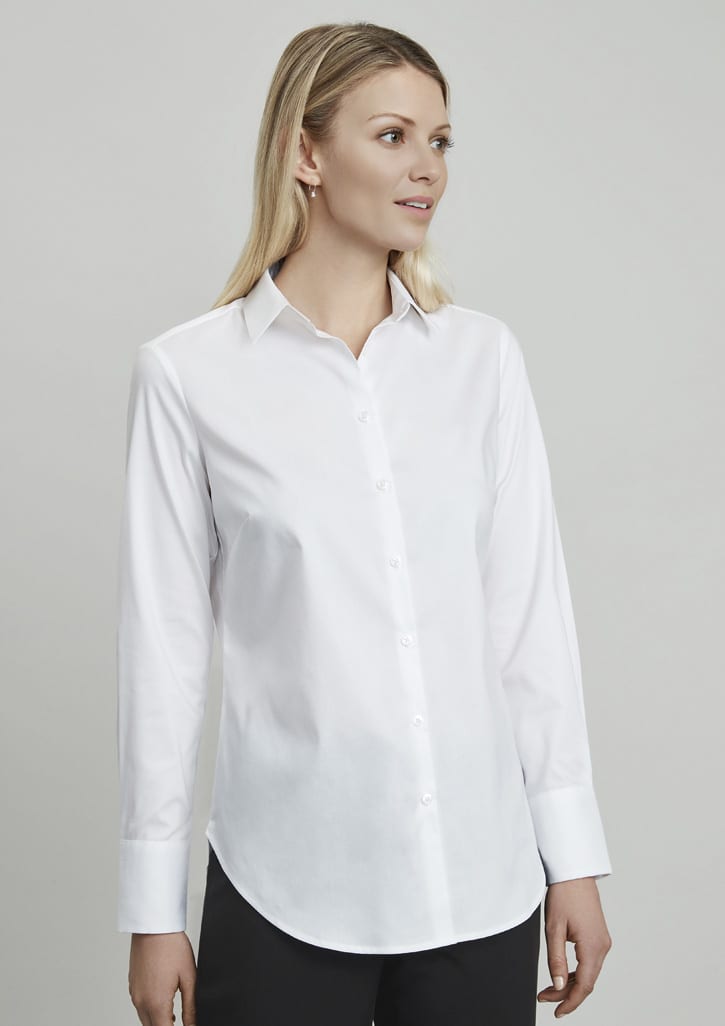 A white long sleeve button-up shirt on a model, featuring a classic collar and a curved hem.