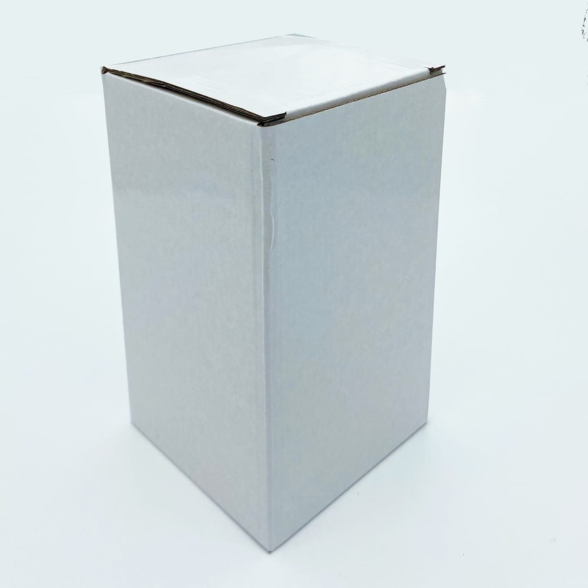 A drink bottle in a plain white box, featuring a square shape and smooth edges. No visible branding.
