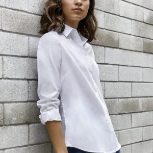 A white long sleeve button-up shirt with a sleek design, displayed against a grey brick wall.