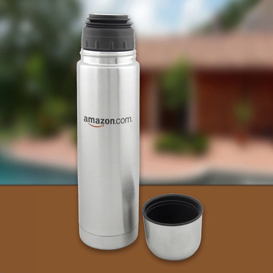 A drink bottle with a silver stainless steel finish, featuring a black lid and a detachable black cup. It has a logo.