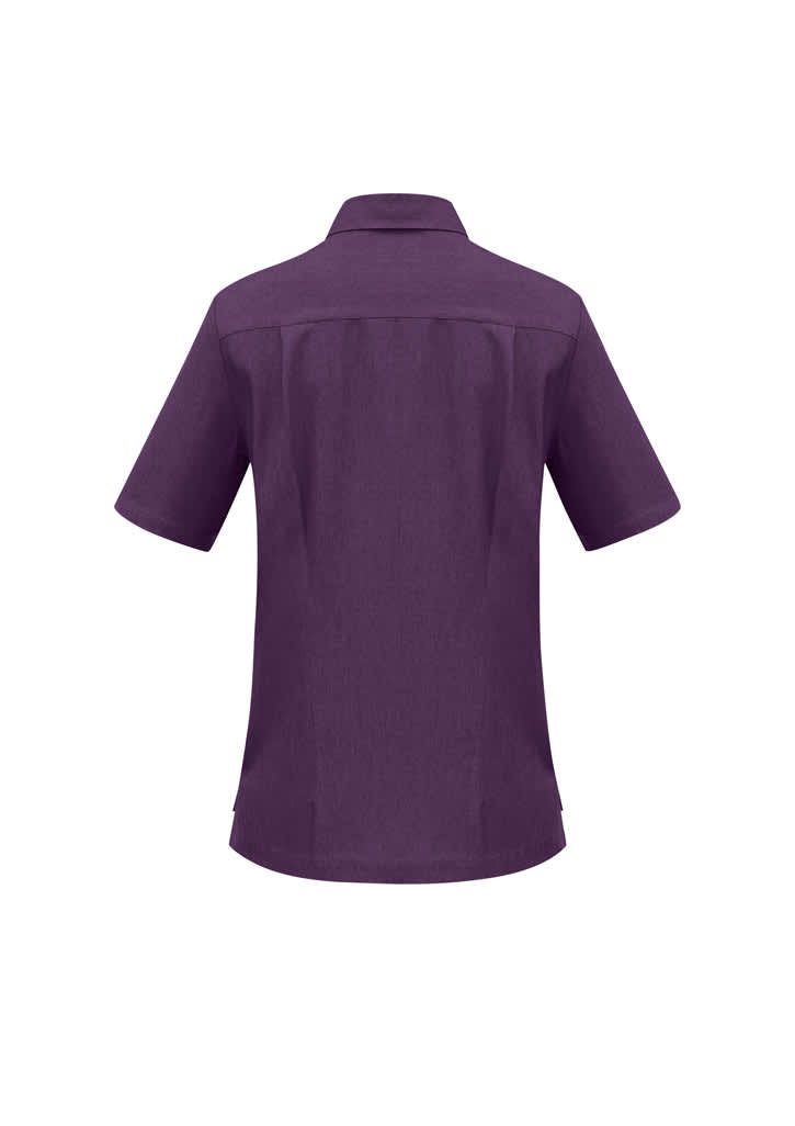 A purple overblouse with short sleeves and a collar, featuring a back yoke detail. It has a logo.