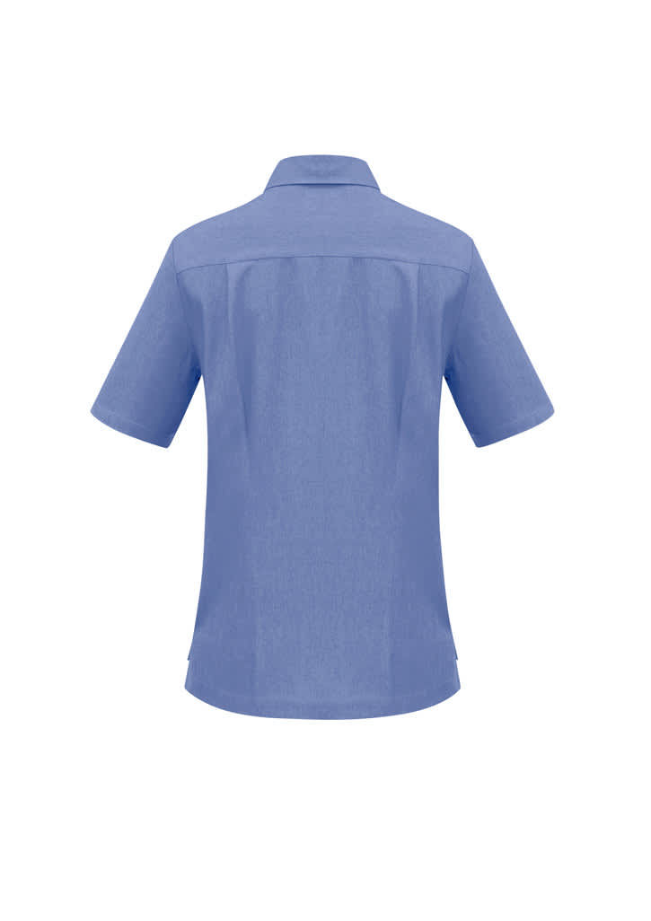A light blue overblouse with short sleeves and a collar, featuring a logo on the back.