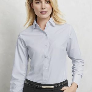 A light blue long sleeve button-up shirt for women, featuring a collar and fitted silhouette. It has a logo on it.