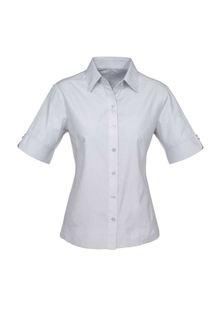 A light grey short-sleeve button-up shirt with a collar and rolled sleeves. It features a logo on the chest.