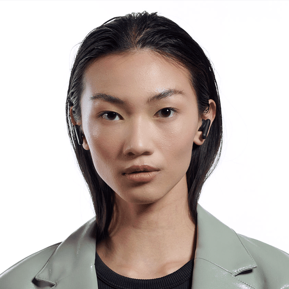 A pair of black Skullcandy Smokin' Buds earbuds worn by a model with long, straight hair, set against a white background.
