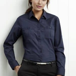 A navy women's button-up long sleeve shirt with two chest pockets and a slim fit. It has a logo on it.