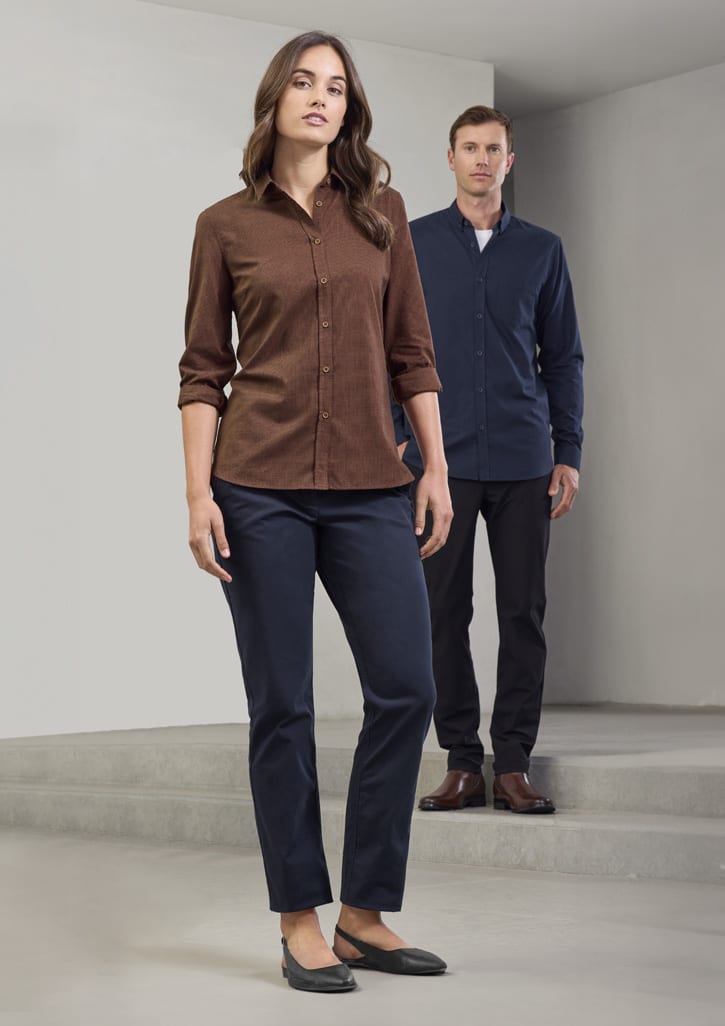A brown long sleeve button-up shirt worn by a woman, paired with dark trousers and complemented by a man in a navy shirt.
