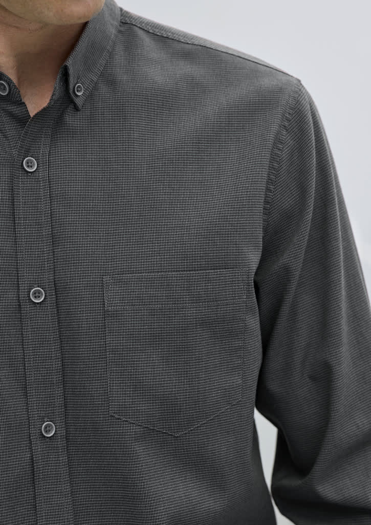 A black and grey patterned long sleeve button-up shirt with a single chest pocket and a logo.