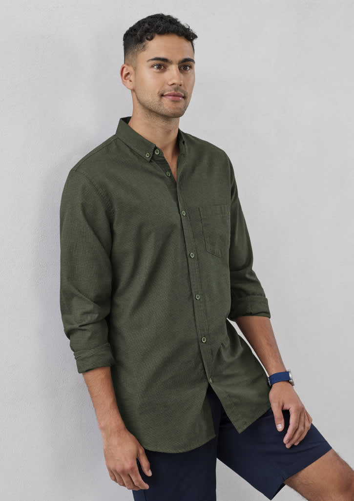 A long sleeve button-up shirt in olive green, featuring a front pocket and a logo.
