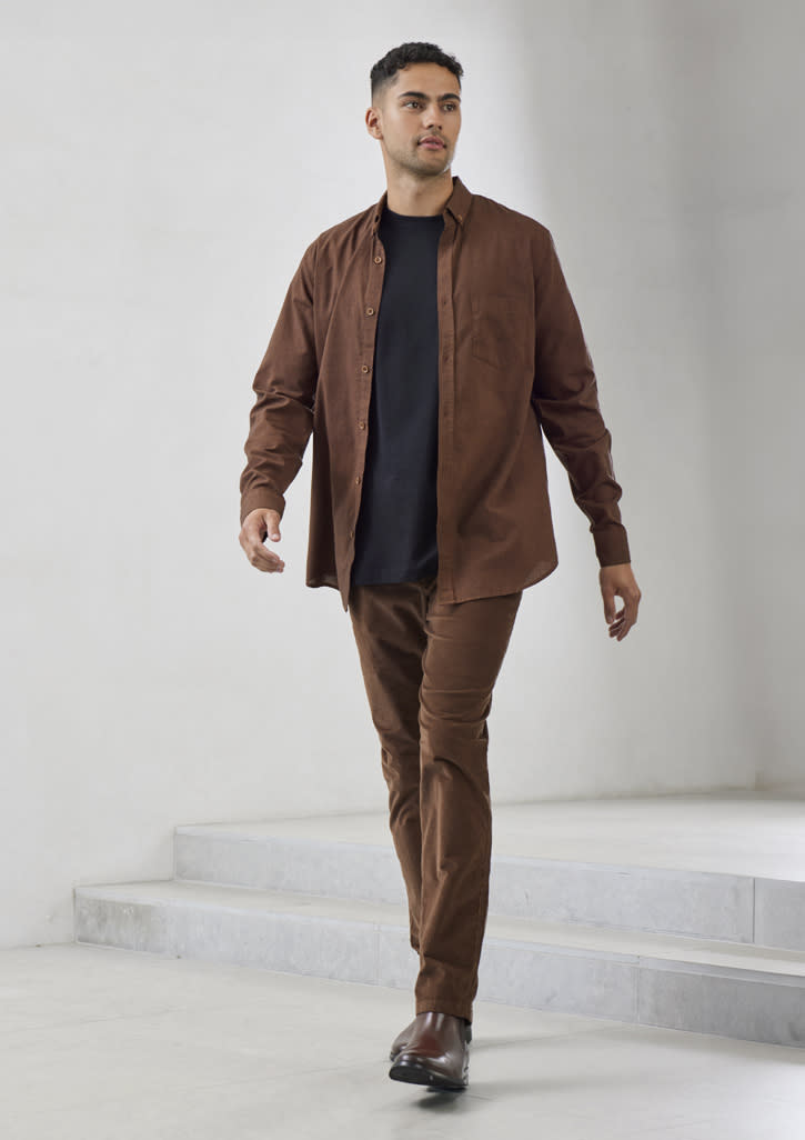 A brown long sleeve button-up shirt worn over a black top, paired with matching brown trousers and shoes.