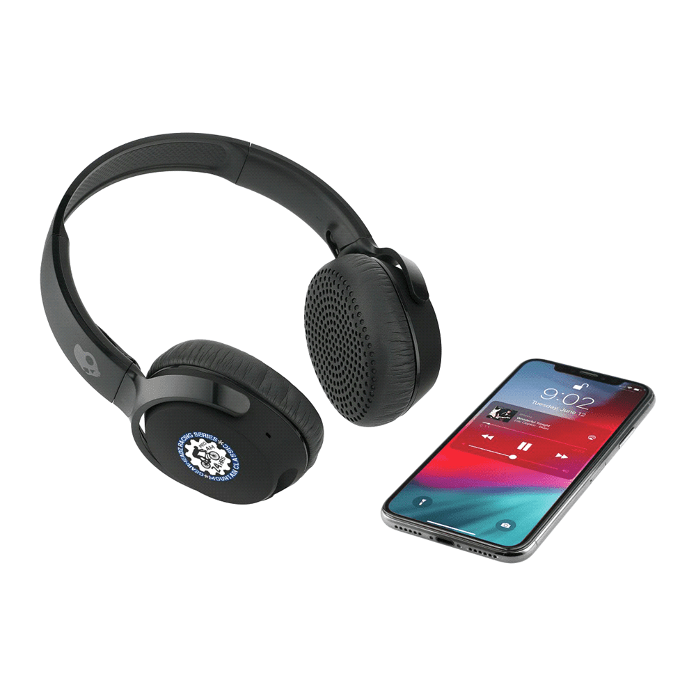 Black Skullcandy Riff Wireless headphones alongside a smartphone displaying a music app. The headphones feature a logo.
