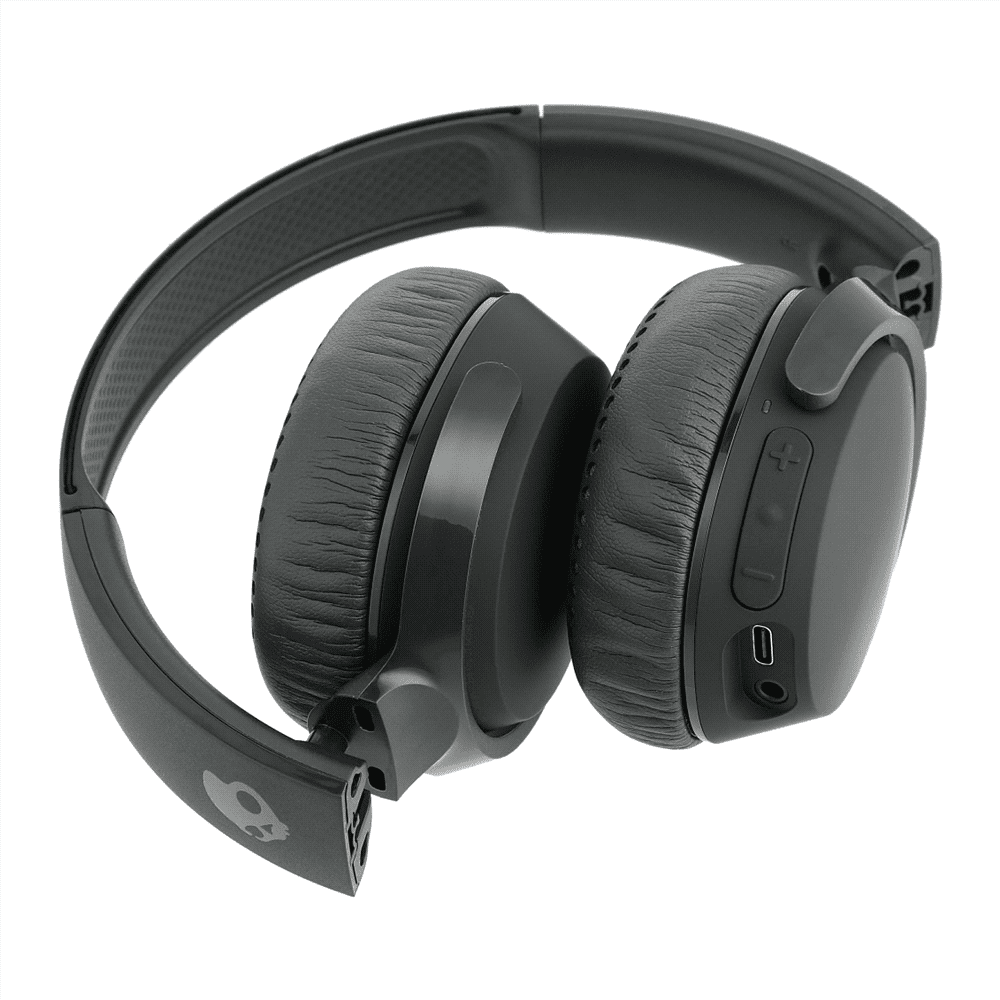 A pair of black wireless headphones with cushioned ear pads and a logo on the side. The headphones feature buttons and a charging port.