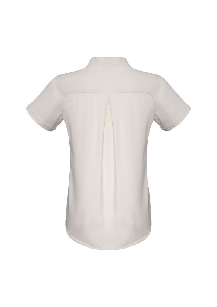 A short sleeve button-up shirt in a cream colour with a back pleat and a logo.