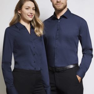 A navy blue long sleeve button-up shirt displayed on a male and female model. The shirt features a logo.