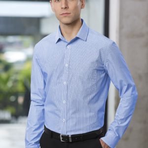 A blue long sleeve button-up shirt worn by a model, featuring a pocket and a logo.