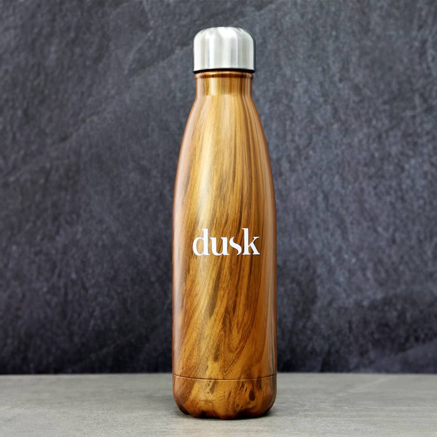 A drink bottle in a wood grain design with a metallic silver lid, featuring a logo.
