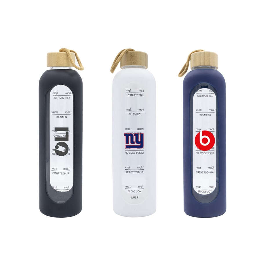 A drink bottle collection featuring navy, white, and black glass options with wooden lids and branding.